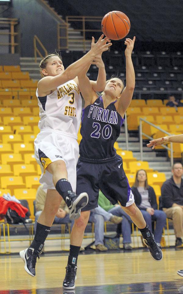 Junior forward Kelsey Sharkey attempts a layup against a Furman defender last week. The Mountaineers lost to Chattanooga Sunday 80-71.  Paul Heckert  |  The Appalachian 