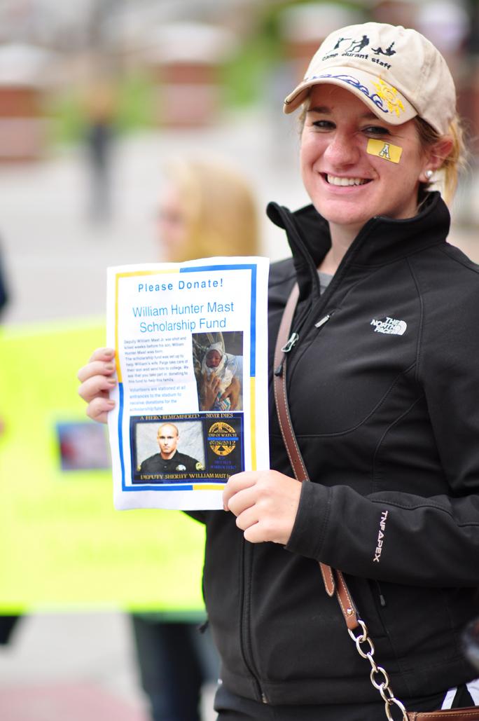 Senior criminal justice major Amy Swanner asks for donations for the William Hunter Mast Scholarship Fund before the start of the football game Sept. 8. 