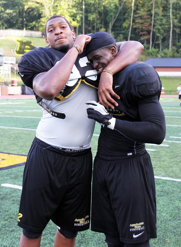 Linebacker Deuce Robinson and defensive tackle Davante Harris pause for a quick shot after a hard practice. The duo has been playing together since high-school and decided Appalachian was their home the first time they stepped on campus. Paul Heckert | The Appalachian 