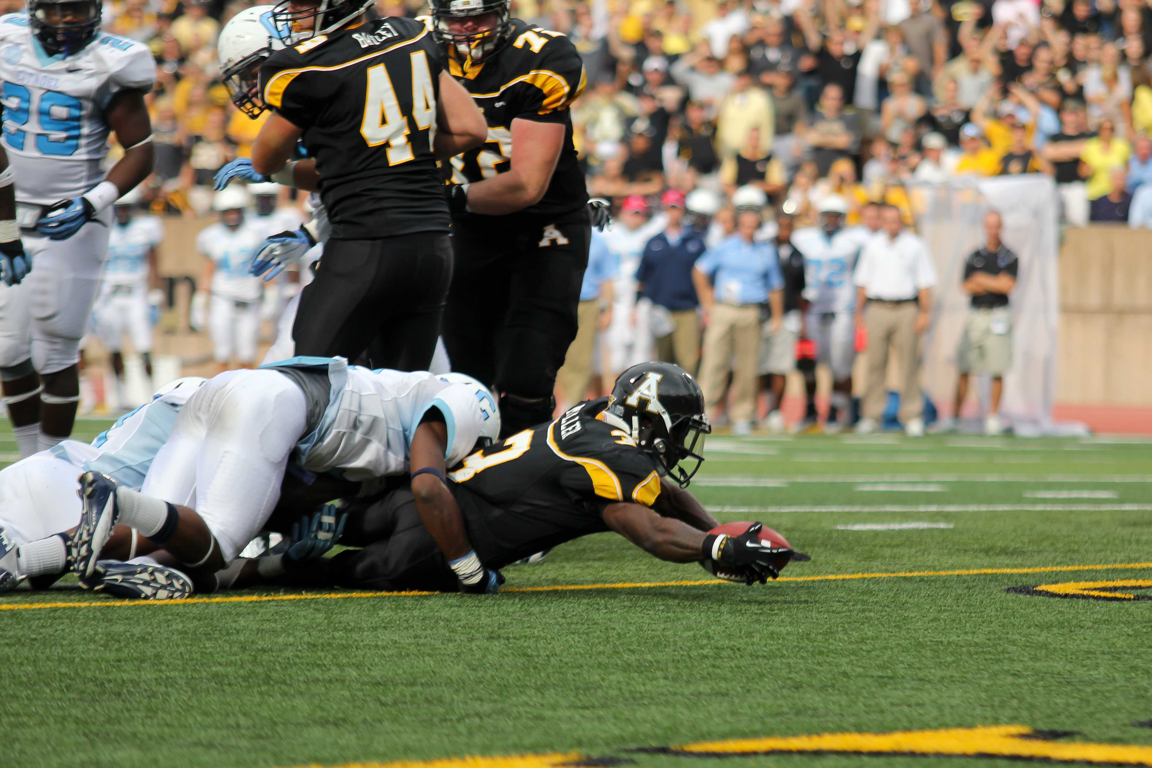 Senior Right-Back Steven Miller stretches across the goal-line for the first touch down of the day on Saturday's game against The Citadel. The Bulldogs won the game 52-28. Paul Heckert | The Appalachian