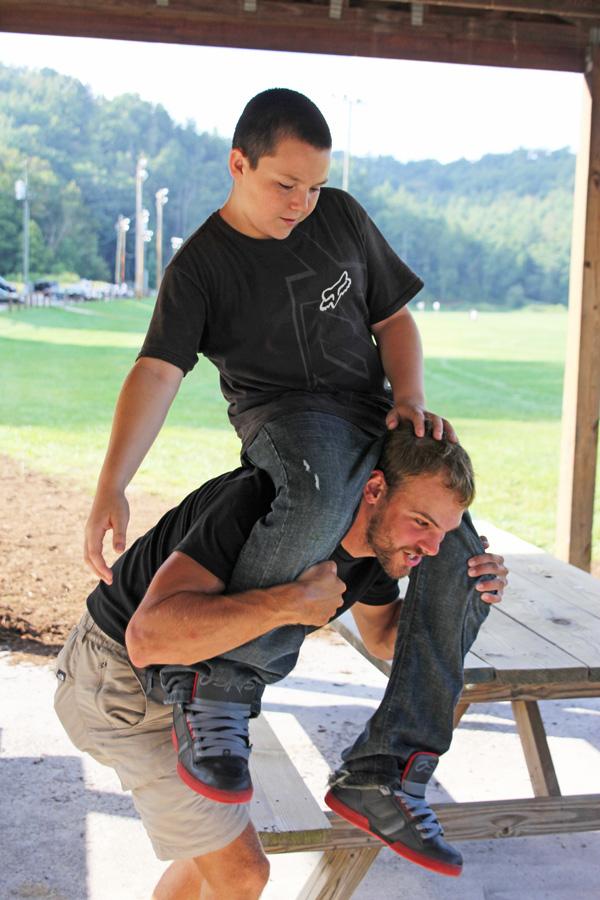 Senior recreation management major Brett Smith lifts his 'little brother' Dylan Johnson onto his shoulder. Brett and Dylan have been paired together for a year through the Western Youth Network. Paul Heckert | The Appalachian