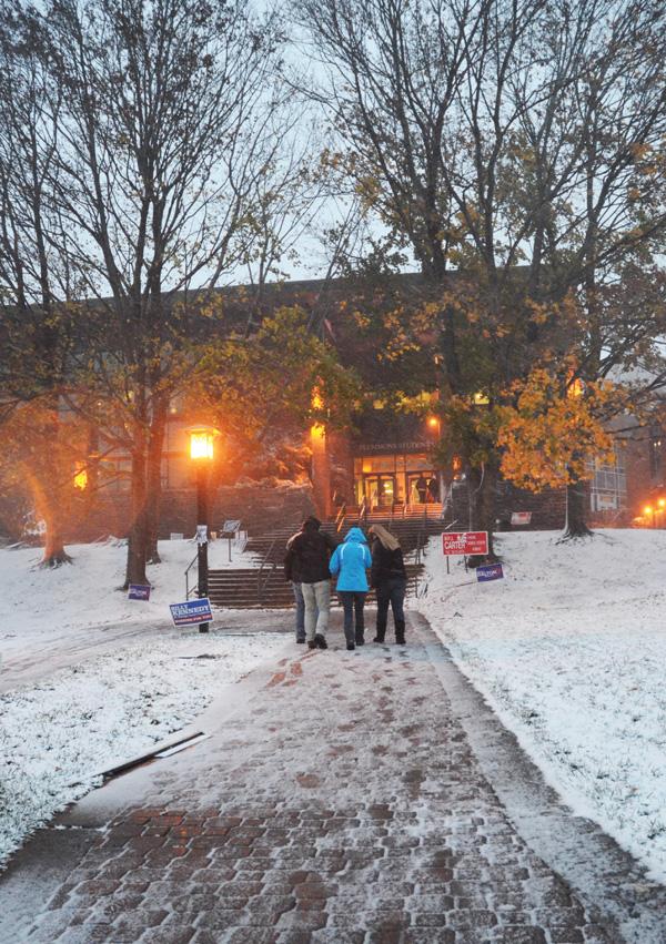 Students brave the snow and wind Monday afternoon as Hurricane Sandy approaches the eastern seaboard. The category 1 hurricane is expected to make landfall by Tuesday morning, with projected winds of up to 60 mph and close to a foot of snow in the area. Justin Perry | The Appalachian 