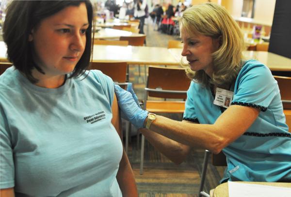 Senior health promotion major Kate Bellingrath receives her free flu shot at the after-hours flu vaccination clinic in Central Dining Hall Wednesday evening. Health Services expects an increase in the number of students receiving flu shots this year. Maggie Cozens | The Appalachian