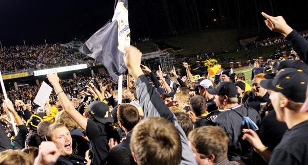 Students storm the field after The Mountaineers took the Paladins for a 33-28 win on Saturday.  Paul Heckert | The Appalachian