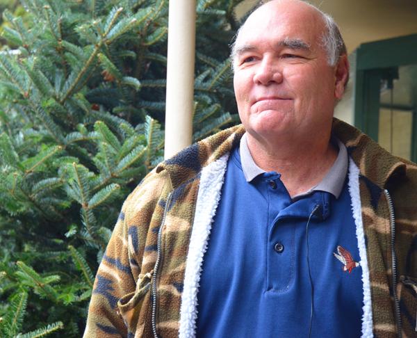 Howard Hughes works as a christmas tree seller at Wahoo's off of highway 321. The christmas trees come from RRR Tree Farm, located in Boone.  Maggie Cozens | The Appalachian