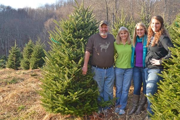 Sophomore accounting major Katelin Fox (third from left) stands with her sister, Nicole (right) and their parents, Ben and Annette, on their family-run Christmas tree farm. The Fox family has been growing Christmas trees in Boone since the early 1990s. Maggie Cozens | The Appalachian