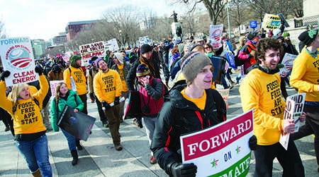 Groups of students form a yellow sea amongst the estimated 40,000 participants as they march down the streets of Washington, D.C. in the ‘Forward on Climate’ rally Sunday afternoon. Around 150 students traveled from Boone wearing shirts that read ‘Fossil Free App State’ to protest the Keystone XL Pipeline.  Olivia Wilkes | The Appalachian 