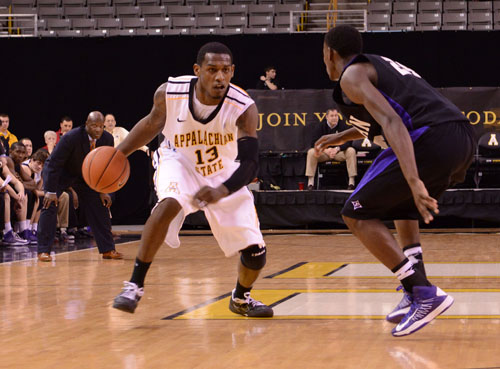 Senior forward Jamaal Trice rounds a Furman defender at mid-court in Monday’s game. The Mountaineers held off the Paladins for a 72-66 win. 