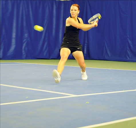 Senior Ellie Linsell backhands the tennis ball during her singles match against the College of Charleston.  Aniesy Cardo  |  The Appalachian