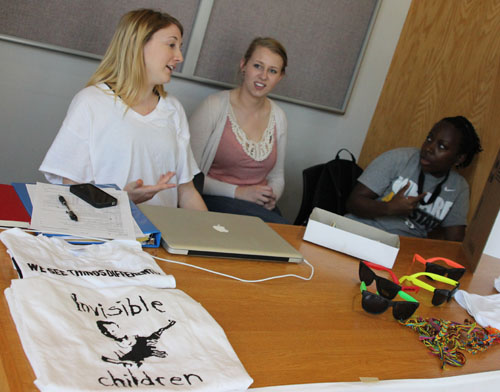 (L-R) Sophomore advertising major Colleen Ratigan, senior English major Stephanie Halchin and freshman advertising major Jelani Drew staff a contact table in Plemmons Student Union on Wednesday morning selling shirts in support of the Appalachian State Invisible Children Club.  Paul Heckert  |  The Appalachian