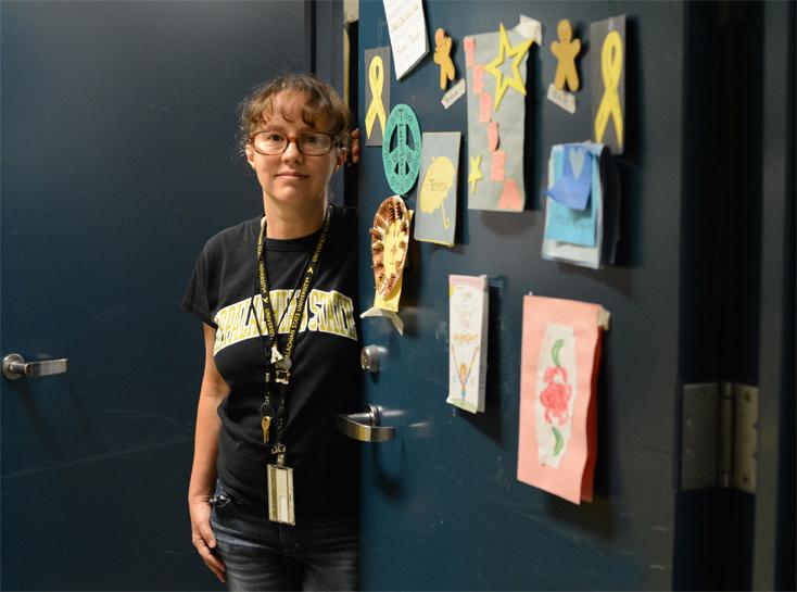 Teresa Davis stands next to her office door, dressed in decorations made by Frank Hall residents. This is Davis’s seventh year working in University Housing.  Olivia Wilkes  |  The Appalachian 