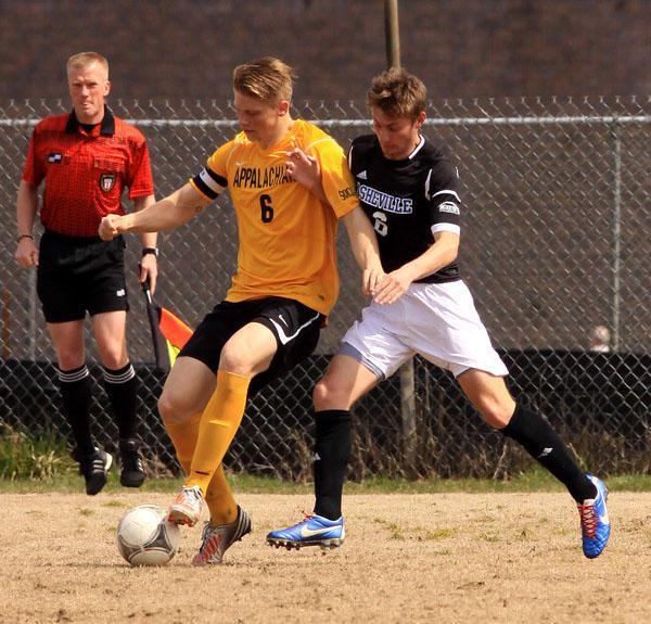 Junior defender Harrison Delbridge keeps the ball from a UNC-Asheville attacker in a game this fall.  Justin Perry  |  The Appalachian