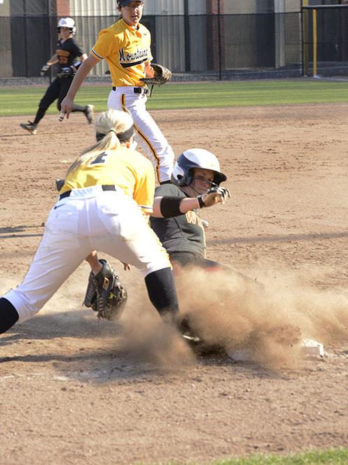 Sophomore catcher Caroline Rogers barely misses outing Winthrop runner at a game earlier this season.  Courtney Roskos  |  The Appalachian