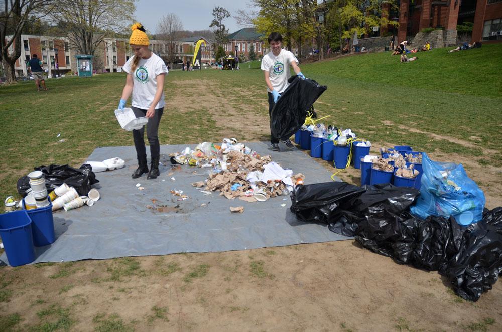 Zero Waste volunteers Christie Horowski and Corie Wallen organize bags of trash into recyclables, trash and compostable materials. They organized 24 bags of trash down to only one bag of trash, the rest being recyclable or compostable.  Nicole Debartolo  |  The Appalachian 