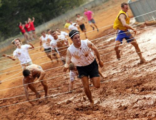 Junior exercise science major Trevor Thomas makes a break from an obstacle in Sunday’s Alpha Delta Pi-sponsored Mud Run held at the High Country Fairgrounds. The run raised $4,872 for the Ronald McDonald House and had 375 participants.  Paul Heckert  |  The Appalachian 