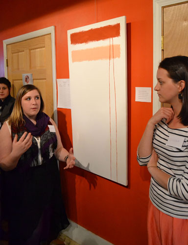 Senior art history major Jasmine Ammon (left) and senior art history and women’s studies major Susan Mackey (right) explain a Rothko-inspired art piece. The painting was one of many pieces by Appalachian State University students on display in Shear Shakti Salon on Friday for the Origins of the World Art Gallery.  Mark Kenna  |  The Appalachian 