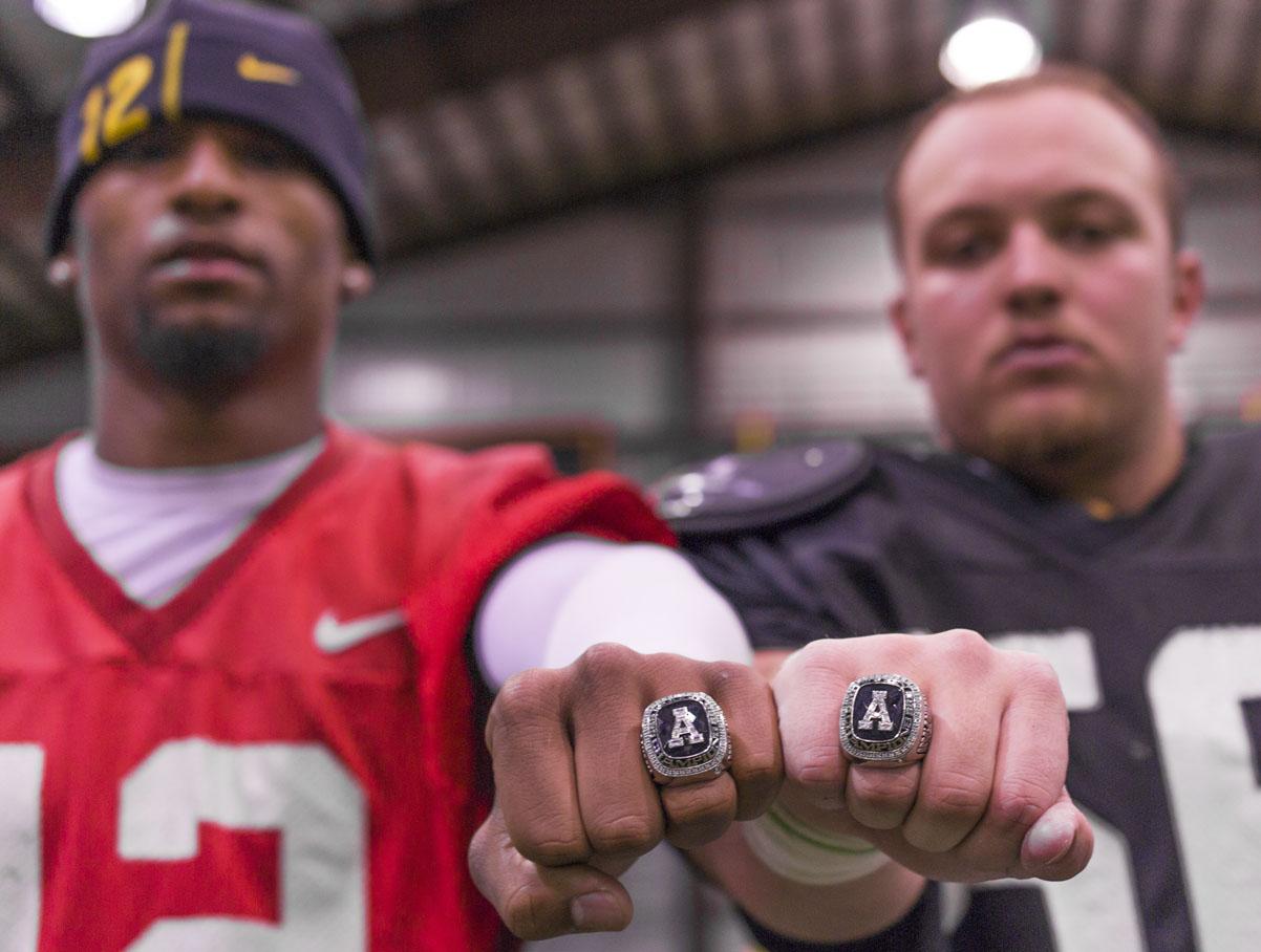 Junior quarterback Jamal Londry-Jackson and freshman defensive lineman Thomas Bronson show off their 2012 SoCon Championship rings. The Mountaineers secured their spot as champions with their win against Furman on November. 10, 2012.  Ansley Cohen  |  The Appalachian