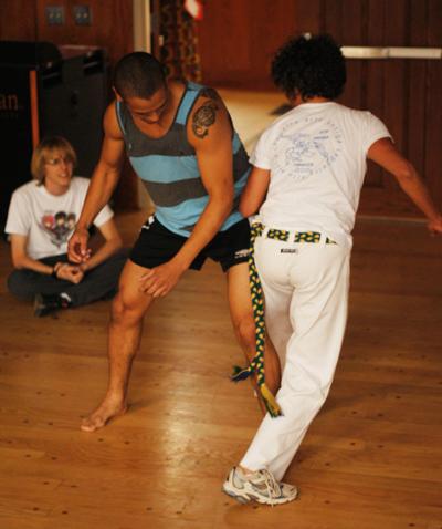 Sophomore management major Josh Blanco (left) practices a capoeira move on lecturer Gabrielle Motta-Passajou (right) in a class offered through the Watauga Global Community. Capoeira is a Brazilian martial art that combines elements of dance and music. There is a workshop followed by a Capoeira performance Friday at 5 p.m. in the Grandfather Ballroom of Plemmons Student Union.  Parker Arnold  | Courtesy Photo