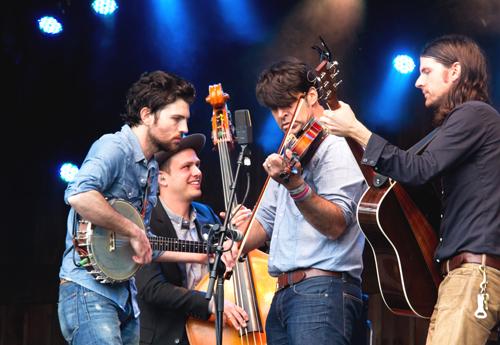 This year’s festival, the first without Watson after 25 years, The Avett Brothers play through heavy rain to close their hour-and-a-half set with ‘Blue Ridge Mountain Blues,’ taught to them by the late Doc Watson, on Sunday at MerleFest 2013.  This year's festival hosted 76,000 participants and focused on the celebration of the life and music of Doc Watson.  Paul Heckert  |  The Appalachian