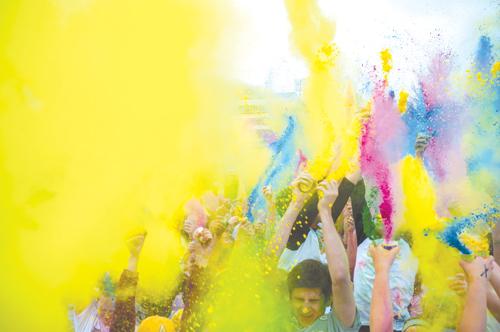 Participants in the first Tie-Dye Dash celebrate the end of the 5K-run by throwing leftover colored powder into the air. Proceeds from the event went to Appalachian and the Community Together and ASU Club Sports.  Justin Perry  |  The Appalachian