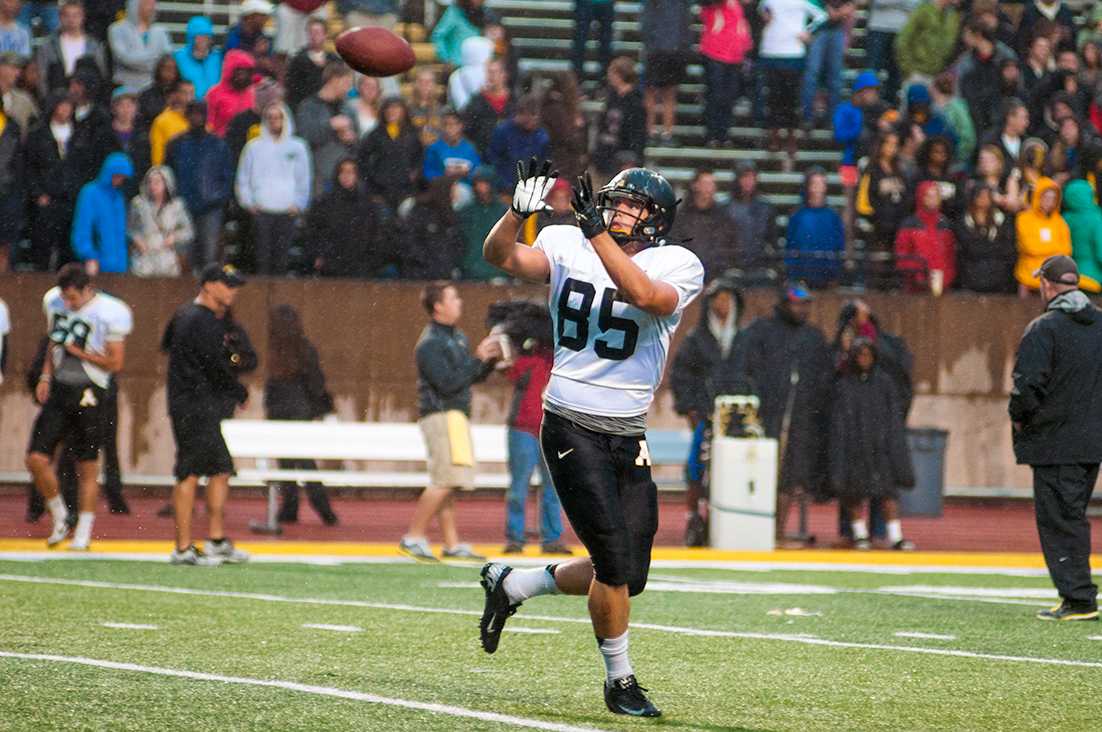 Freshman tight end Barrett Burns warms up before the start of Appalachian Football's annual Fan Fest on Saturday. Despite constant rain, approximately 4,500 fans showed up to watch the 93-play scrimmage.  Justin Perry  |  The Appalachian