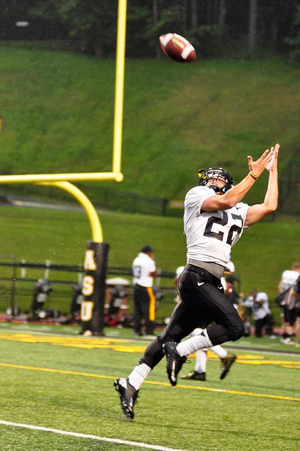 Sophomore wide reciever Seth Sloane catches the ball while warming up for Appalachian Football's annual Fan Fest on Saturday. Despite constant rain, approximately 4,500 fans showed up to the scrimmage. Photo by Rachel Krauza | The Appalachian