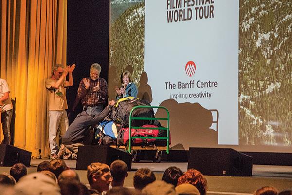 Godfrey Masauli, one of the directors of the film “The Boy Who Flies,” receives a set of paragliding equipment from local business owners at the 17th annual Banff Festival on Saturday. Photo by Lovey Cooper  |  The Appalachian