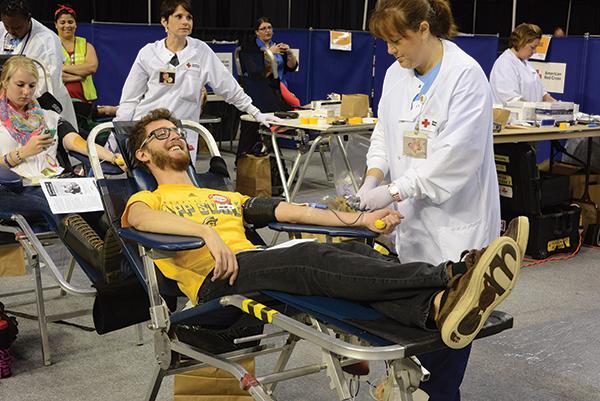 Junior appropriate technology major Matthew Swails smiles while donating blood at the “Saved by the Blood” blood drive. Photo by Courtney Roskos  |  The Appalachian