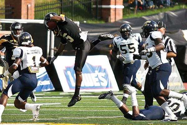 Wide receiver Tony Washington hurdles over a Chattanooga defender during the Mountaineers’ 14-12 victory over Chattanooga during the 2011 season. Appalachian State will face Chattanooga at Kidd Brewer Stadium on Saturday. File Photo  |  The Appalachian