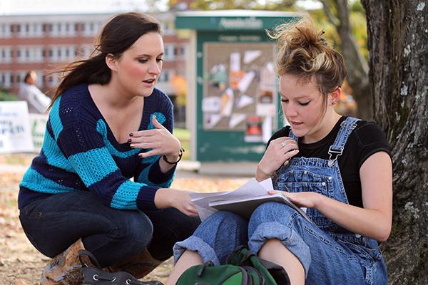 Write-in mayoral candidate Jenny Church helps freshman psychology major Ivy Beth Abernethy (right) register to vote on the Appalachian State University campus’ Sanford Mall. Church who is a senior at Appalachian State, stood on the lawn of the campus helping passing students and faculty register to vote in Boone. Photo by Molly Cogburn  |  The Appalachian