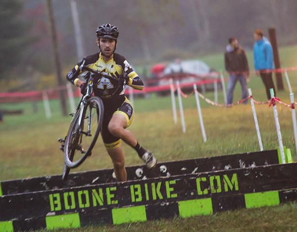 Junior appropriate technology major Baird Sills dismounts to hop a barrier during the Boone Bike and Touring sponsored cyclocross race. Photo by Paul Heckert  |  The Appalachian