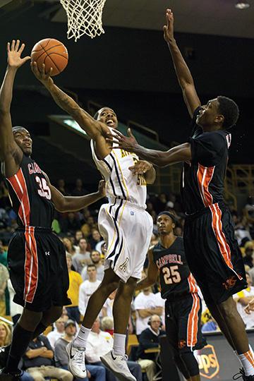 Junior guard Mike Neal squeezes through the defense toward the basket during Tuesday night’s home opener against Campbell. The Camels beat the Mountaineers 73-66. Photo by Paul Heckert  |  The Appalachian