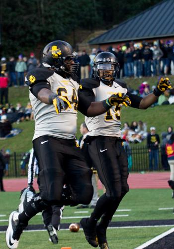 Junior lineman Tucker Lee congratulates senior wide receiver Tony Washington after second quarter touchdown in the Mountaineer's 48-27 win over Western Carolina.  Paul Heckert  |  The Appalachian