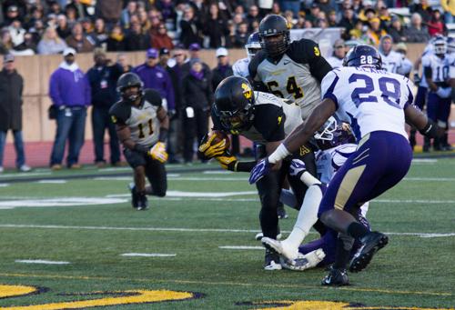 Freshman running back Marcus Cox breaks through two Western defenders for a touchdown in the Mountaineer's 48-27 win over Western Carolina.  Paul Heckert  |  The Appalachian