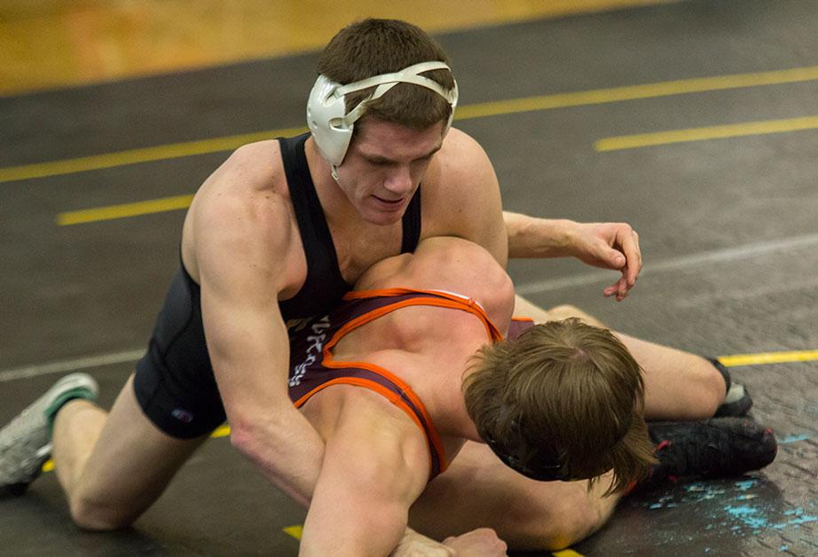 Senior Collins Creech keeps hold of Virginia Tech wrestler early on in Saturday's tournament held in the Varsity Gym. Photo by Paul Heckert | The Appalachian