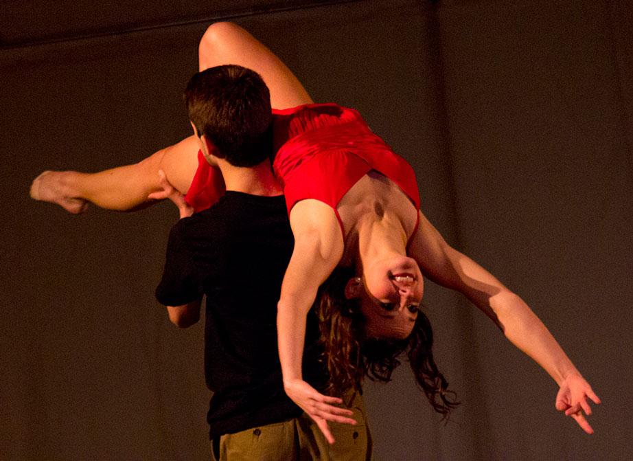 Sophomore communication major Aliana Brown is lifted by freshman dance studies major Andrew Benson in their performance of “high School Sweethearts” Friday night at the Momentum Dance Festival held in the Varsity Gym Dance studio. The festival included 8 performances that showcased the talents of the Momentum Dance Club. Photo by Paul Heckert