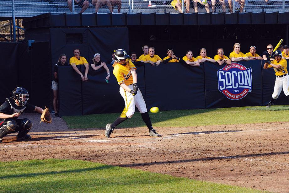 Junior outfielder Ashley Seering hits her first home run last season (above). Junior catcher Caroline Rogers misses outing Winthrop player last season (right). File photo | The Appalachian