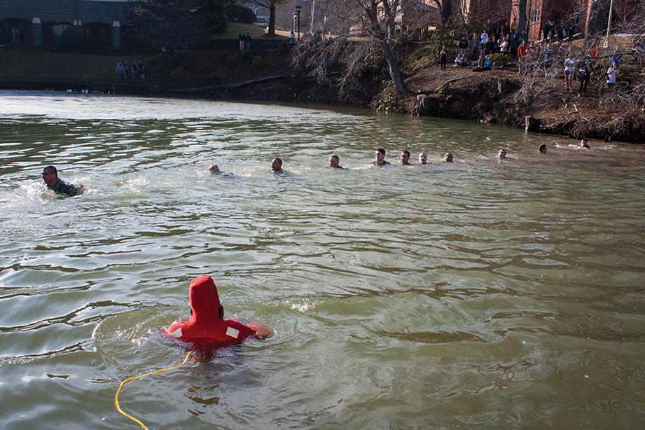 Members of the Appalachian State Army ROTC cross Duck Pond before their jump in Thursday afternoon's Polar Plunge.