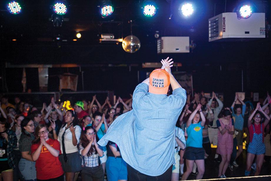 Alumna Sarah Kasper leads the crowd in dance at the Dance Marathon.