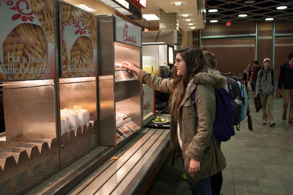 Junior psychology major Kaity Pechanek picks up dinner from the Chik-fil-A, located in Central Dining Hall. SGA is currently working with Food Services to create late-night dining on campus along with offering Chik-fil-A breakfast. Photo by Rachel Krauza | The Appalachian