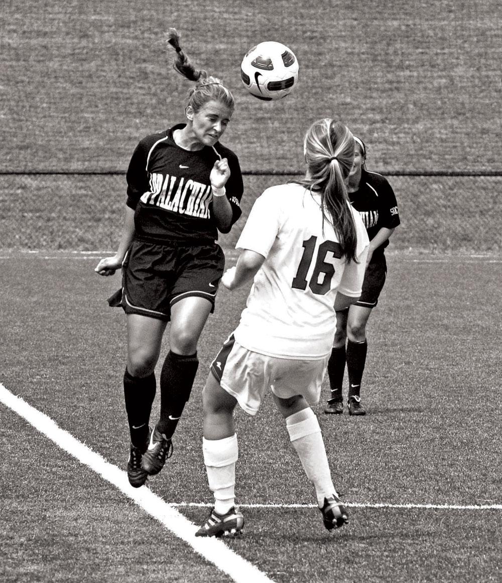 An Appalachian State soccer player heads the ball. Brittany Bolick will join the Appalachian State women’s soccer coaching staff next season as the team joins the Sun Belt Conference. Photo by Olivia Wilkes | The Appalachian