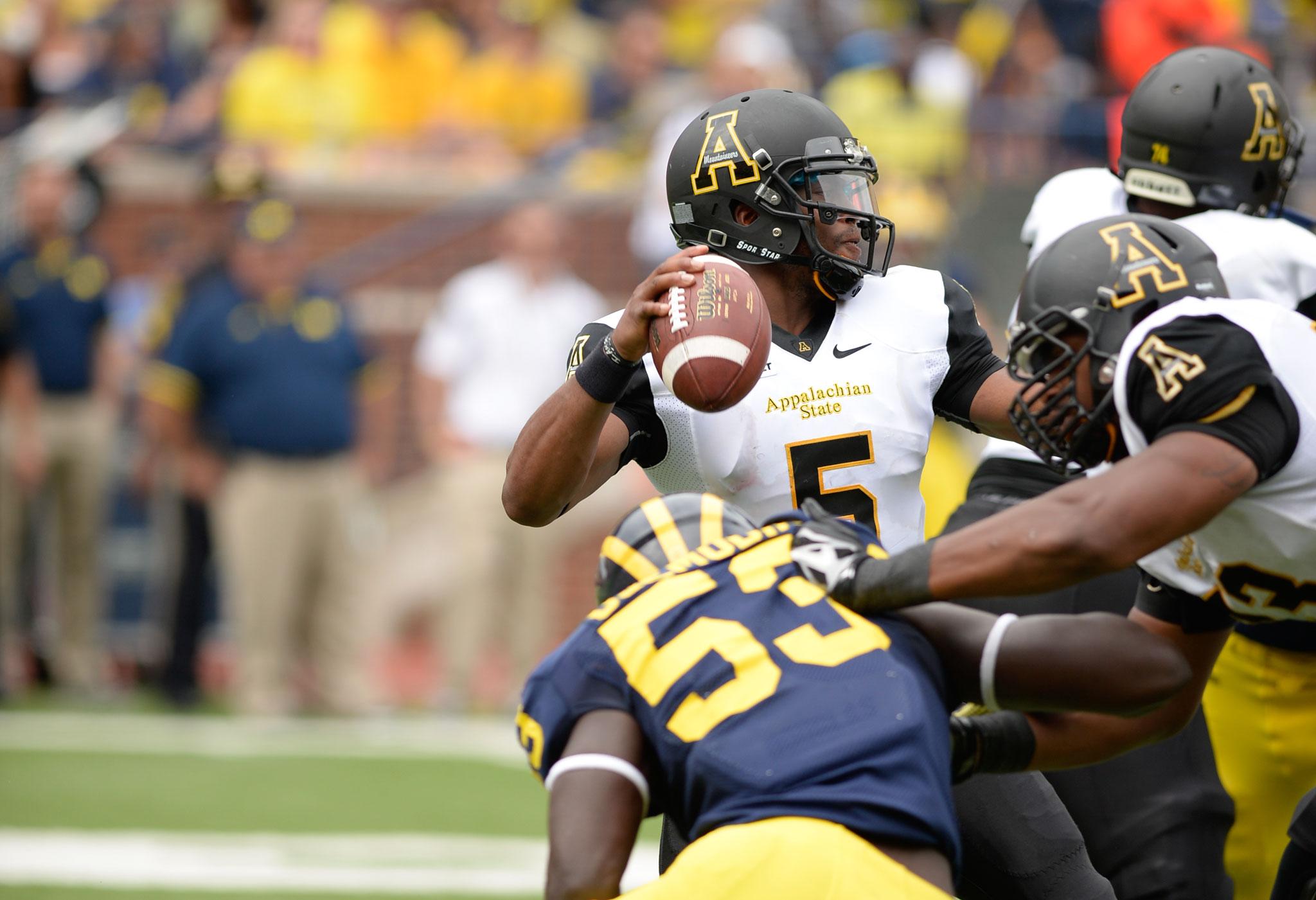 Junior quarterback Kameron Bryant fights to pass the ball down the field during the second half of Saturday's season opener against Michigan. The Mountaineers fell to the Wolverines 52-14. Photo by Justin Perry  |  The Appalachian