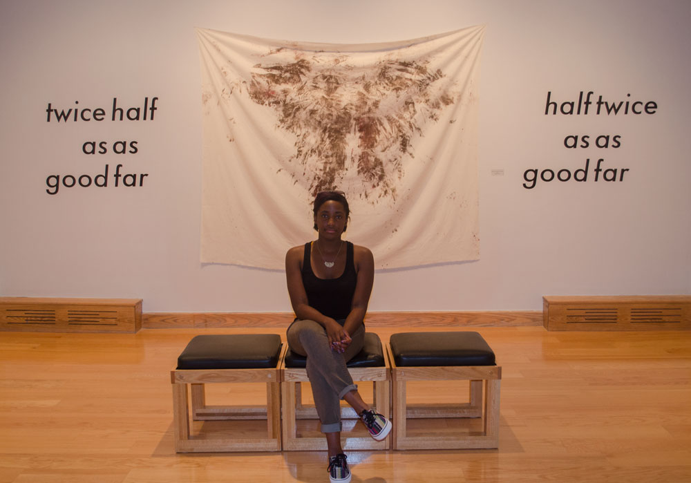 Senior studio art major Renee Cloud in her exhibit "No One Sits Next to the Black Girl on the Bus" on display in the Looking Glass Gallery in Plemmons Student Union this semester. Cloud pulled personal experiences from her childhood in a single-parent home to create the artwork in the exhibit. Photo by Morgan Cook | The Appalachian